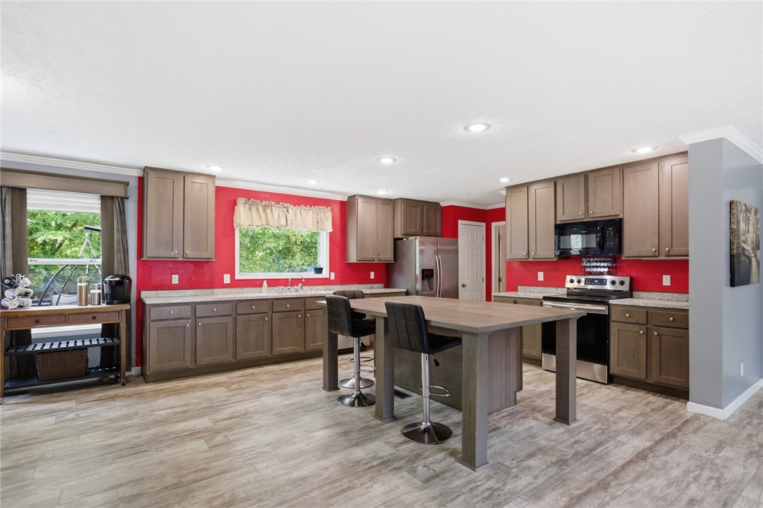 119 Fruit Mountain Road Easley, SC 29640 - Photo 9 of 31 This spacious kitchen offers ample cabinet space and a central island, perfect for entertaining.