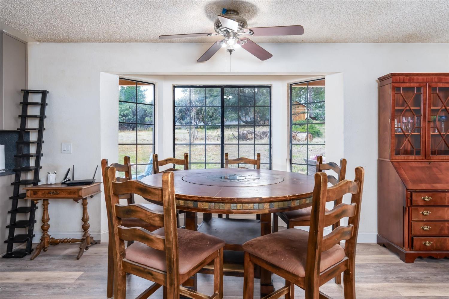 5785 Glacier Point Mariposa, CA 95338 - Photo 15 of 38 a view of a dining room with furniture window and wooden floor
