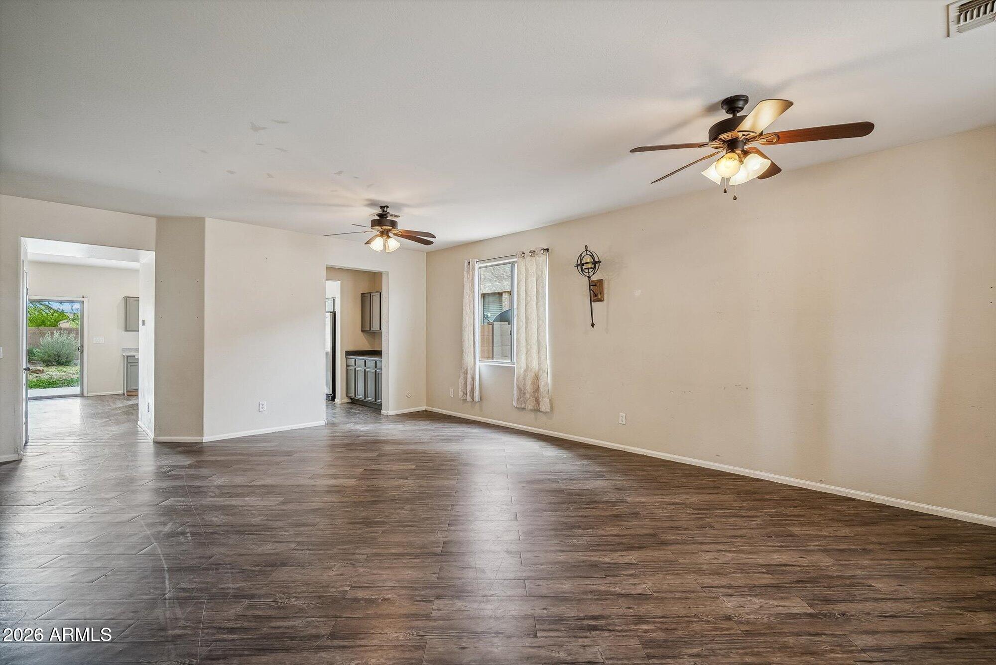 3903 East Citrine Road San Tan Valley, AZ 85143 - Photo 11 of 34 a view of empty room with wooden floor and fan