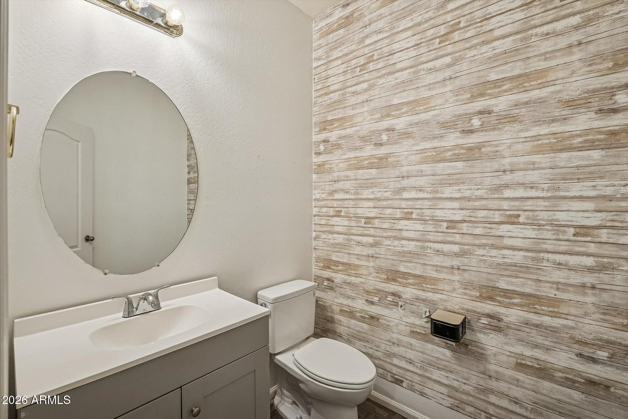 3903 East Citrine Road San Tan Valley, AZ 85143 - Photo 12 of 34 a bathroom with a toilet a sink and mirror