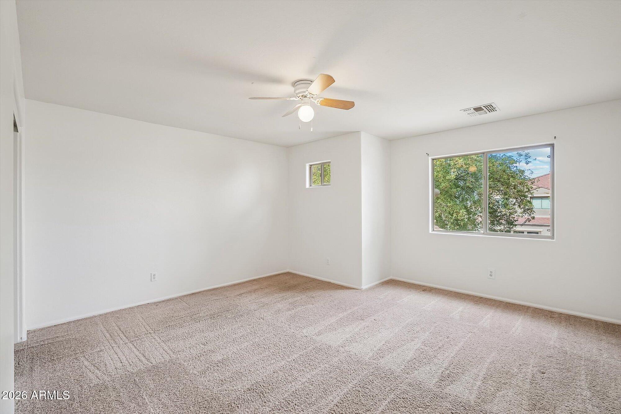 3903 East Citrine Road San Tan Valley, AZ 85143 - Photo 20 of 34 an empty room with windows and fan