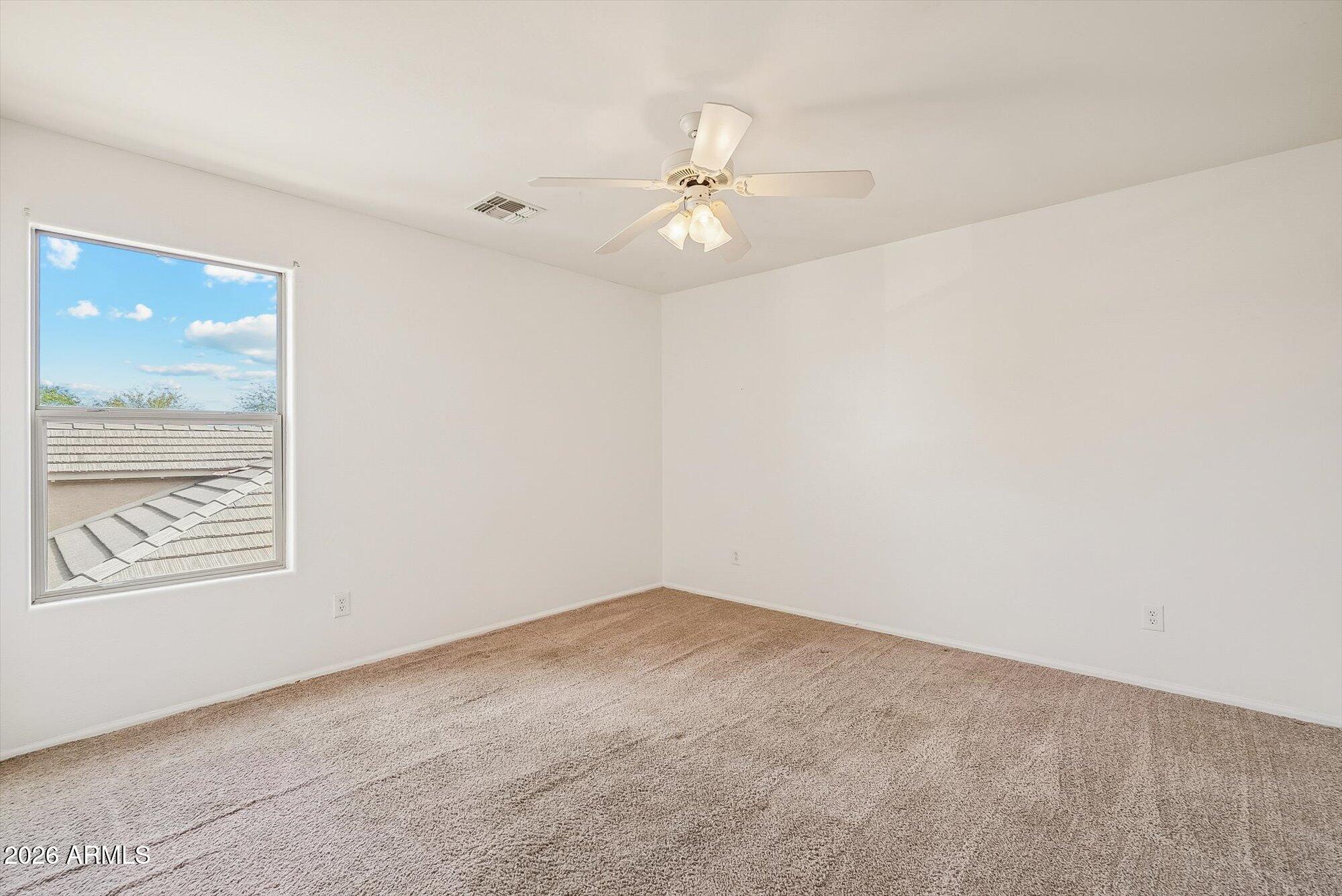 3903 East Citrine Road San Tan Valley, AZ 85143 - Photo 21 of 34 an empty room with windows and fan