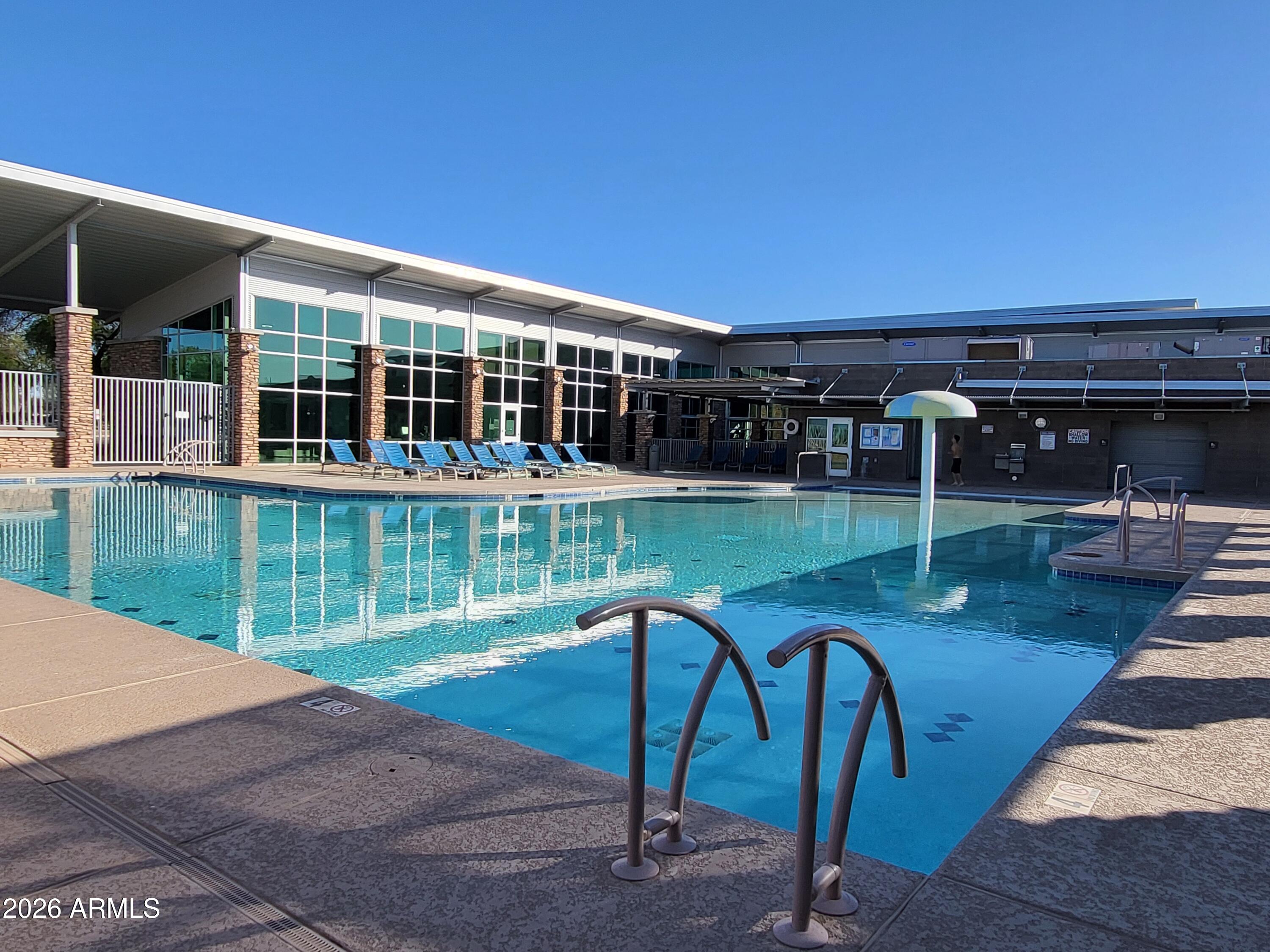 3903 East Citrine Road San Tan Valley, AZ 85143 - Photo 28 of 34 a roof deck with table and chairs and potted plants