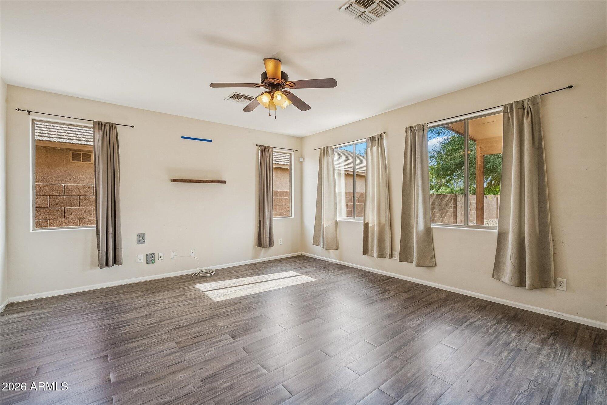 3903 East Citrine Road San Tan Valley, AZ 85143 - Photo 8 of 34 a view of an empty room with wooden floor and a window