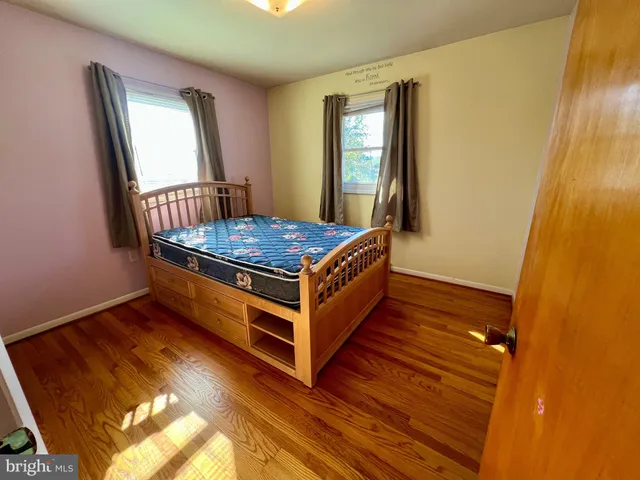 a room with wooden floor and furniture