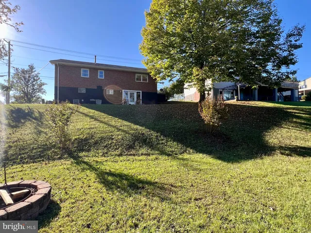 a front view of a house with a yard and a garden