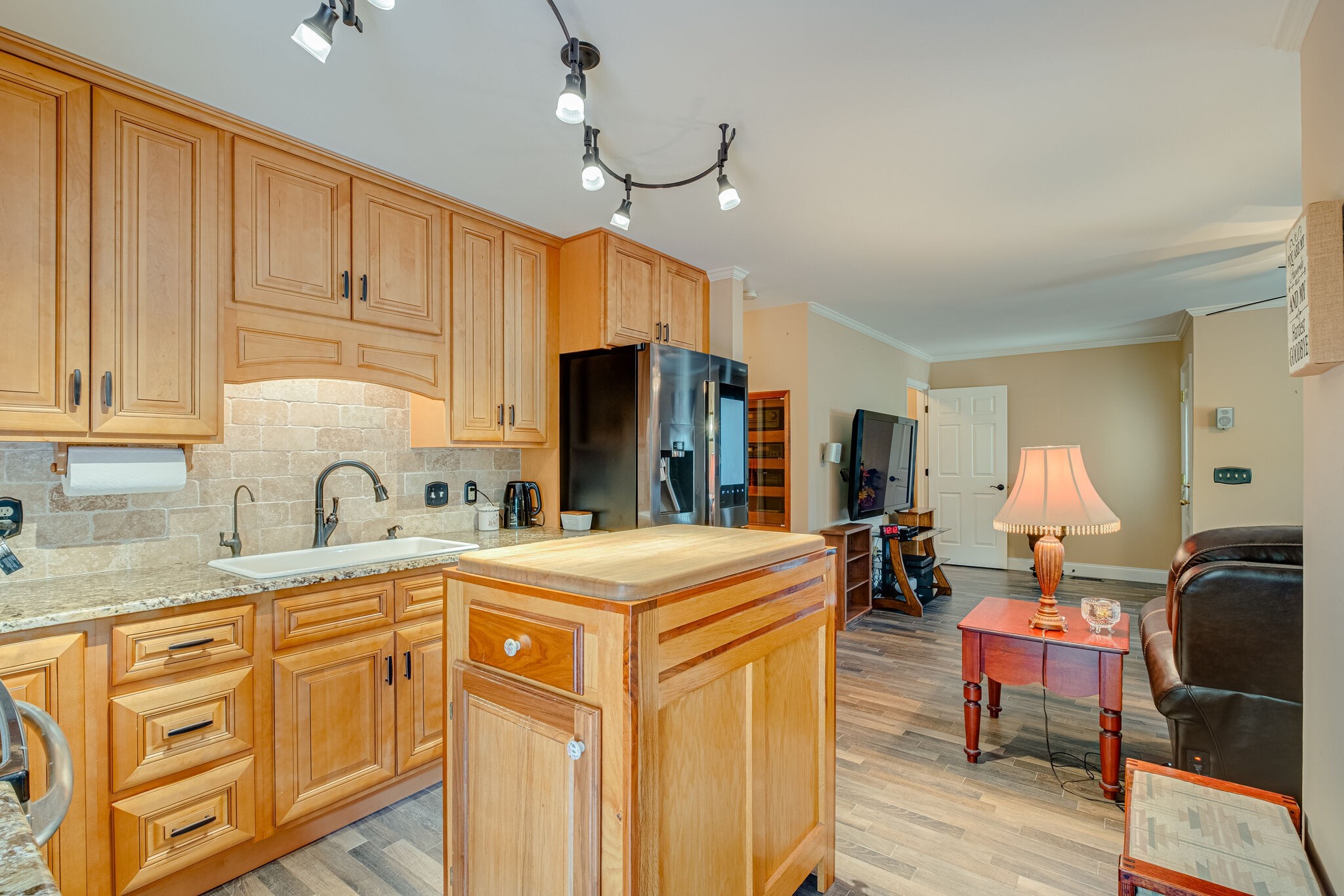 1303 John Sharp Road Columbia, TN 38401 - Photo 11 of 53 a kitchen with stainless steel appliances granite countertop a sink a stove cabinets dining table and chairs