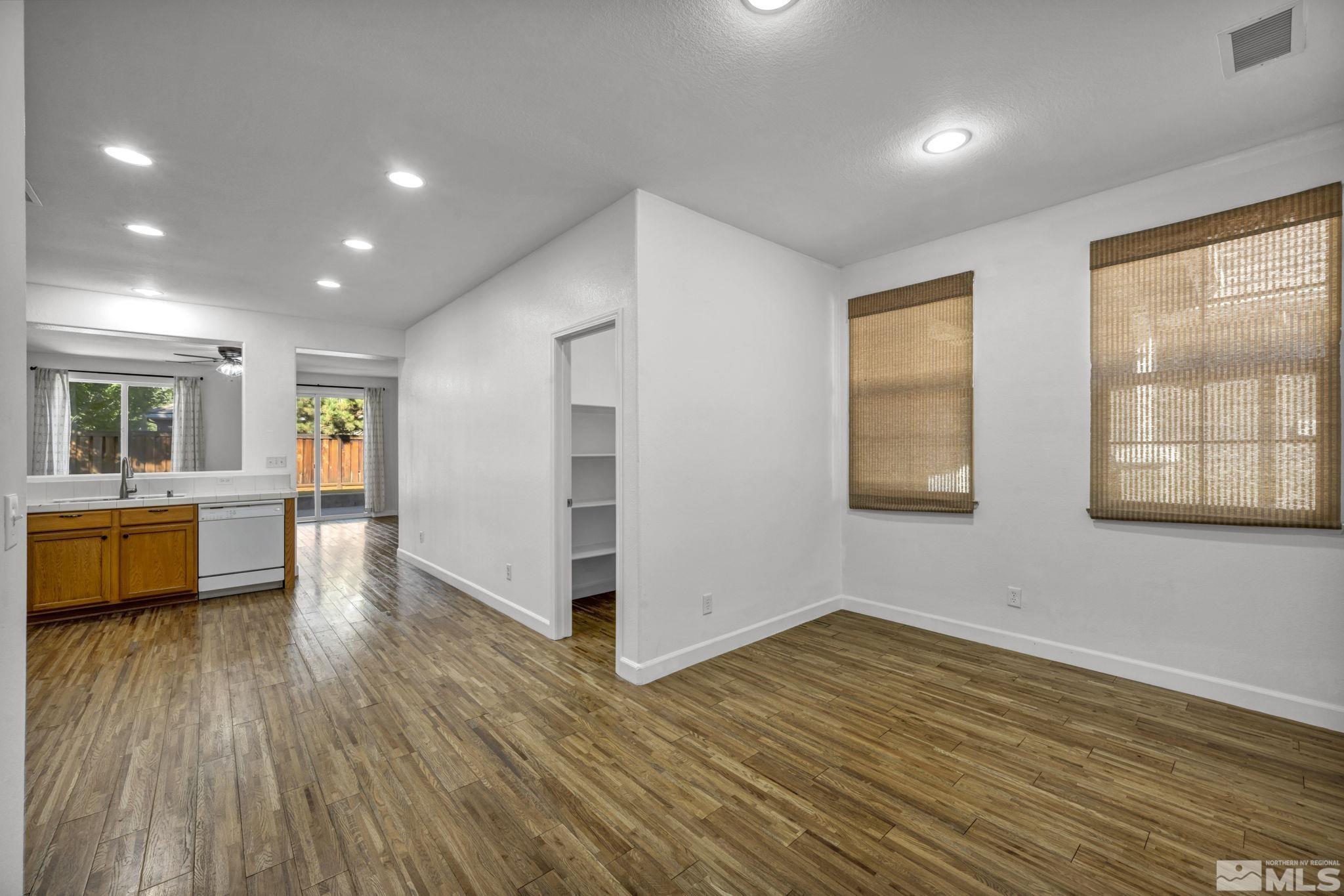 11275 Torino Way Reno, NV 89521 - Photo 15 of 37 an empty room with wooden floor and windows
