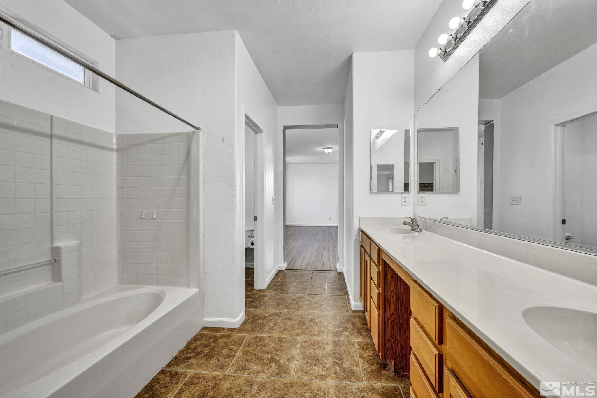 11275 Torino Way Reno, NV 89521 - Photo 20 of 37 a bathroom with a tub sink and mirror