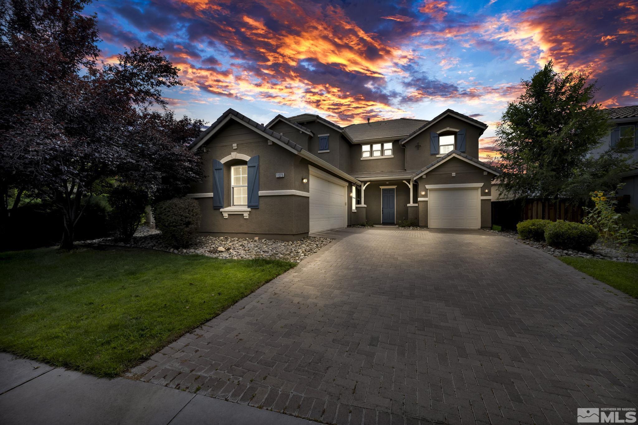 11275 Torino Way Reno, NV 89521 - Photo 28 of 37 a front view of a house with a garden and trees