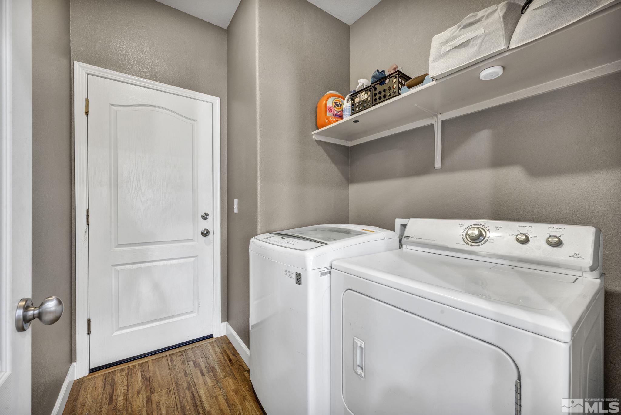 11275 Torino Way Reno, NV 89521 - Photo 31 of 37 a view of washer and dryer with kitchen in the background