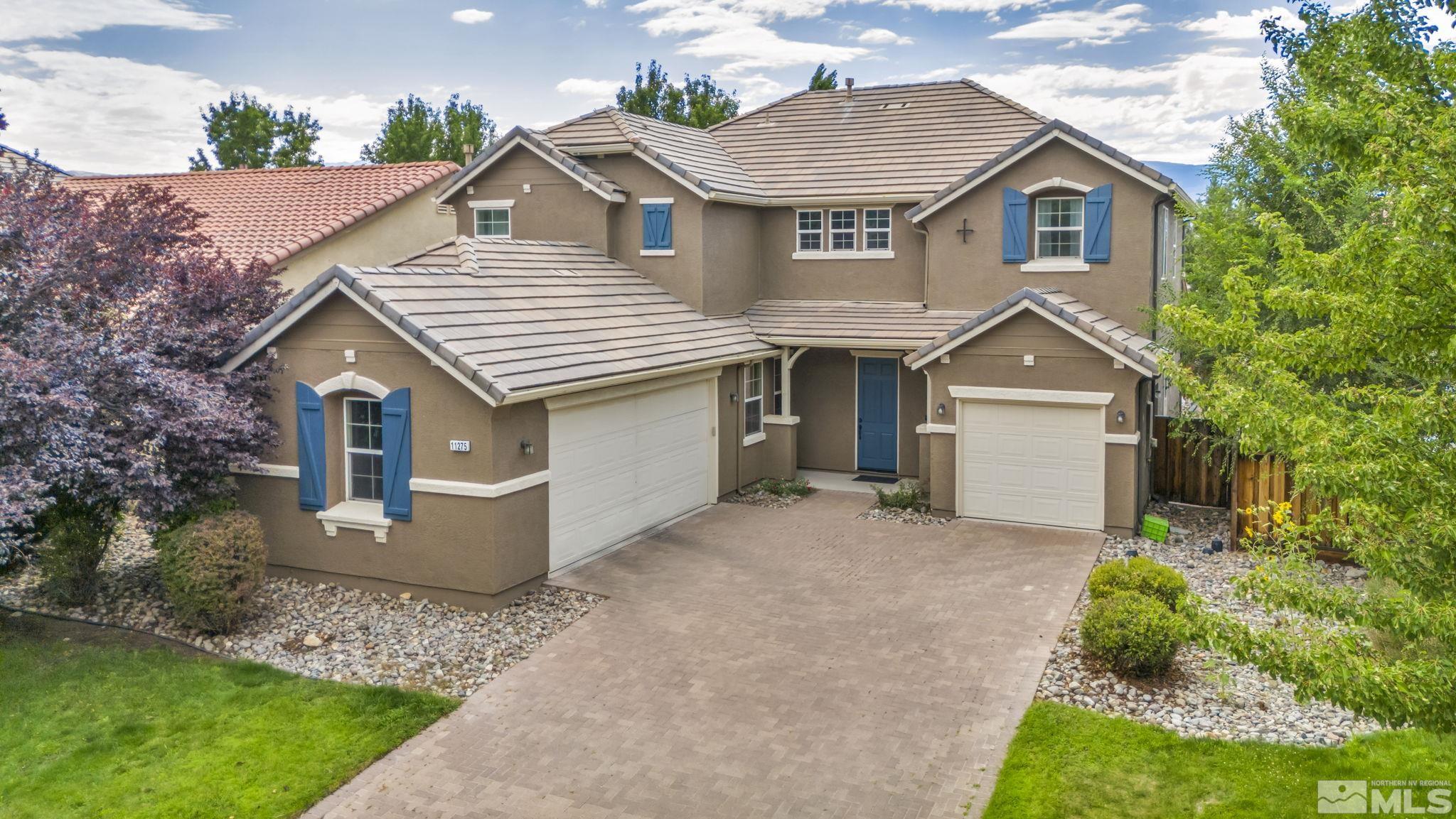 11275 Torino Way Reno, NV 89521 - Photo 35 of 37 a front view of a house with a yard and garage