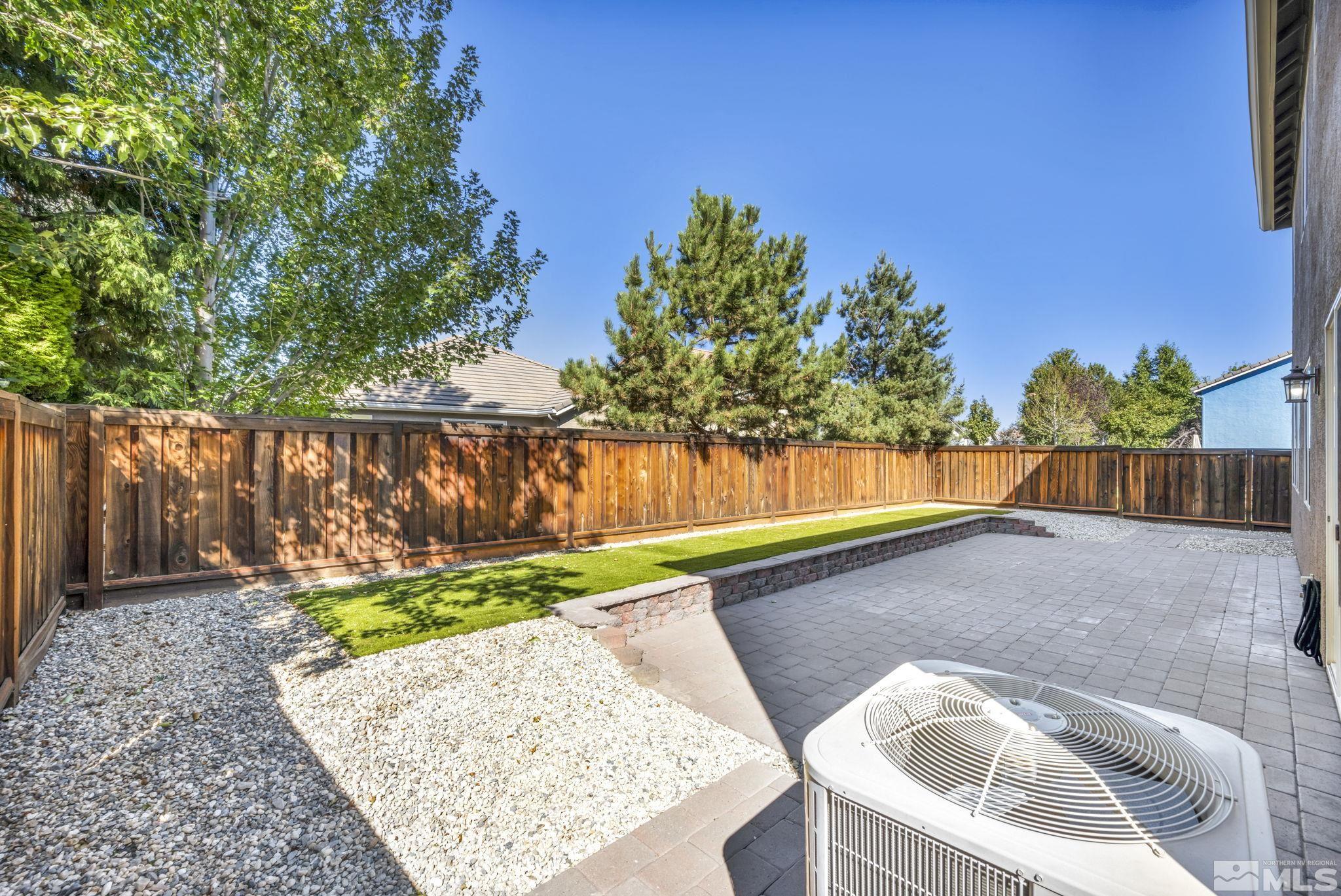 11275 Torino Way Reno, NV 89521 - Photo 6 of 37 a view of backyard with tree and wooden fence
