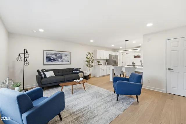 a living room with furniture and a coffee table with wooden floor