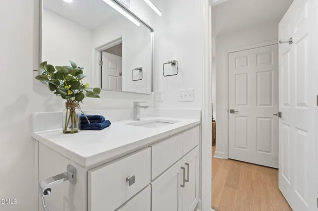 a bathroom with a sink a vanity and a mirror