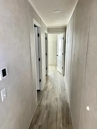 a view of a hallway with wooden floor