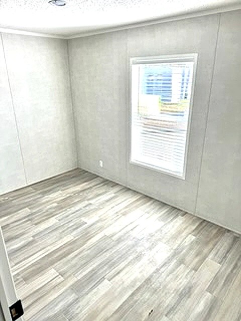 295 Cotham Drive Huntingdon, TN 38344 - Photo 15 of 19 a view of an empty room with wooden floor and a window