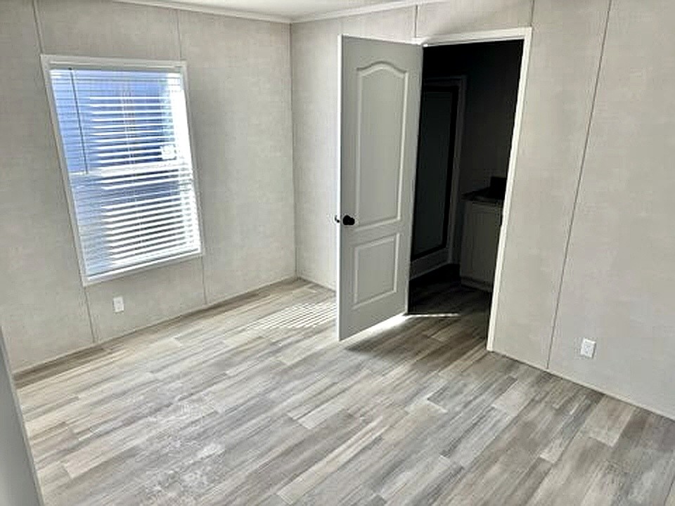 295 Cotham Drive Huntingdon, TN 38344 - Photo 7 of 19 a view of wooden floor and windows in a room