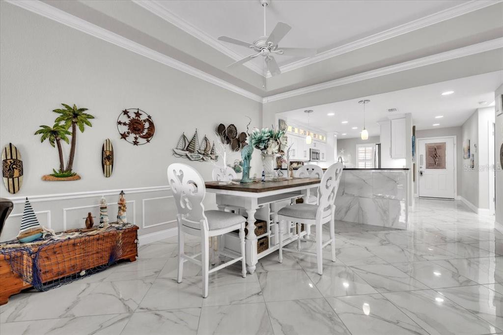 1260 Rio De Janeiro Avenue, Unit 102 Punta Gorda, FL 33983 - Photo 11 of 46 a dining room with furniture and a chandelier
