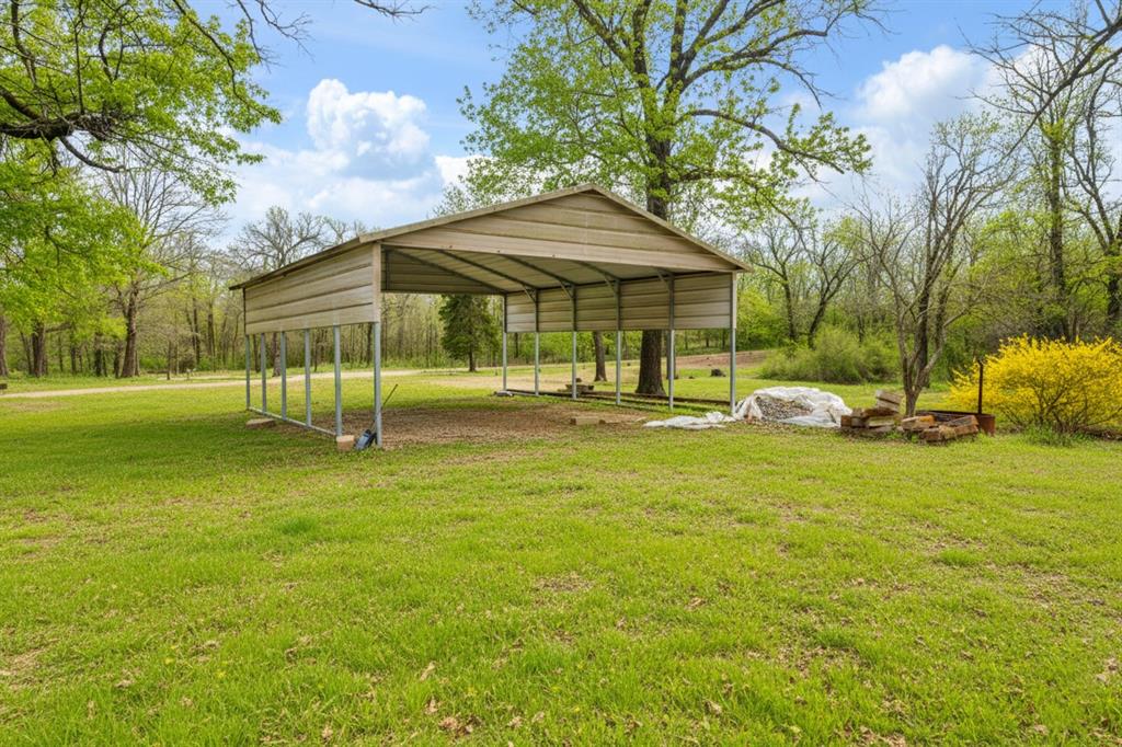 595 County Road Powderly, TX 75473 - Photo 15 of 25 a backyard of a house with barbeque oven table and chairs