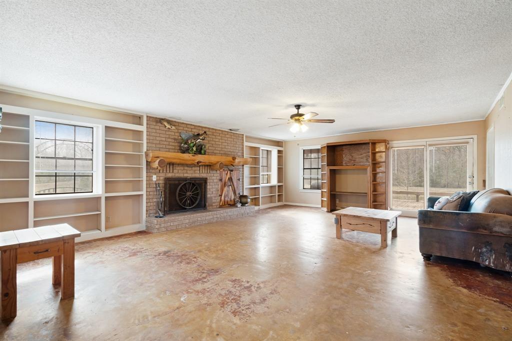 595 County Road Powderly, TX 75473 - Photo 2 of 25 a living room with furniture and a fireplace
