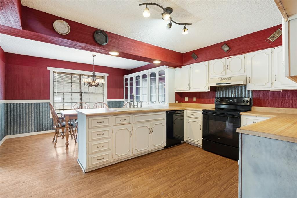 595 County Road Powderly, TX 75473 - Photo 5 of 25 a kitchen with stainless steel appliances granite countertop a stove cabinets and wooden floors