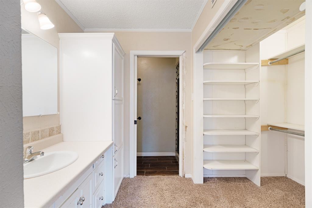 595 County Road Powderly, TX 75473 - Photo 8 of 25 a bathroom with a double vanity sink a toilet and a vanity