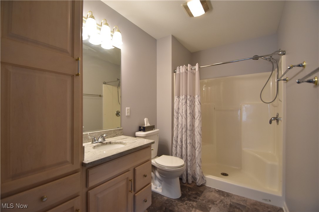 603 South Raccoon Road, Unit 49 Youngstown, OH 44515 - Photo 16 of 27 Bathroom featuring a shower with shower curtain, toilet, and vanity
