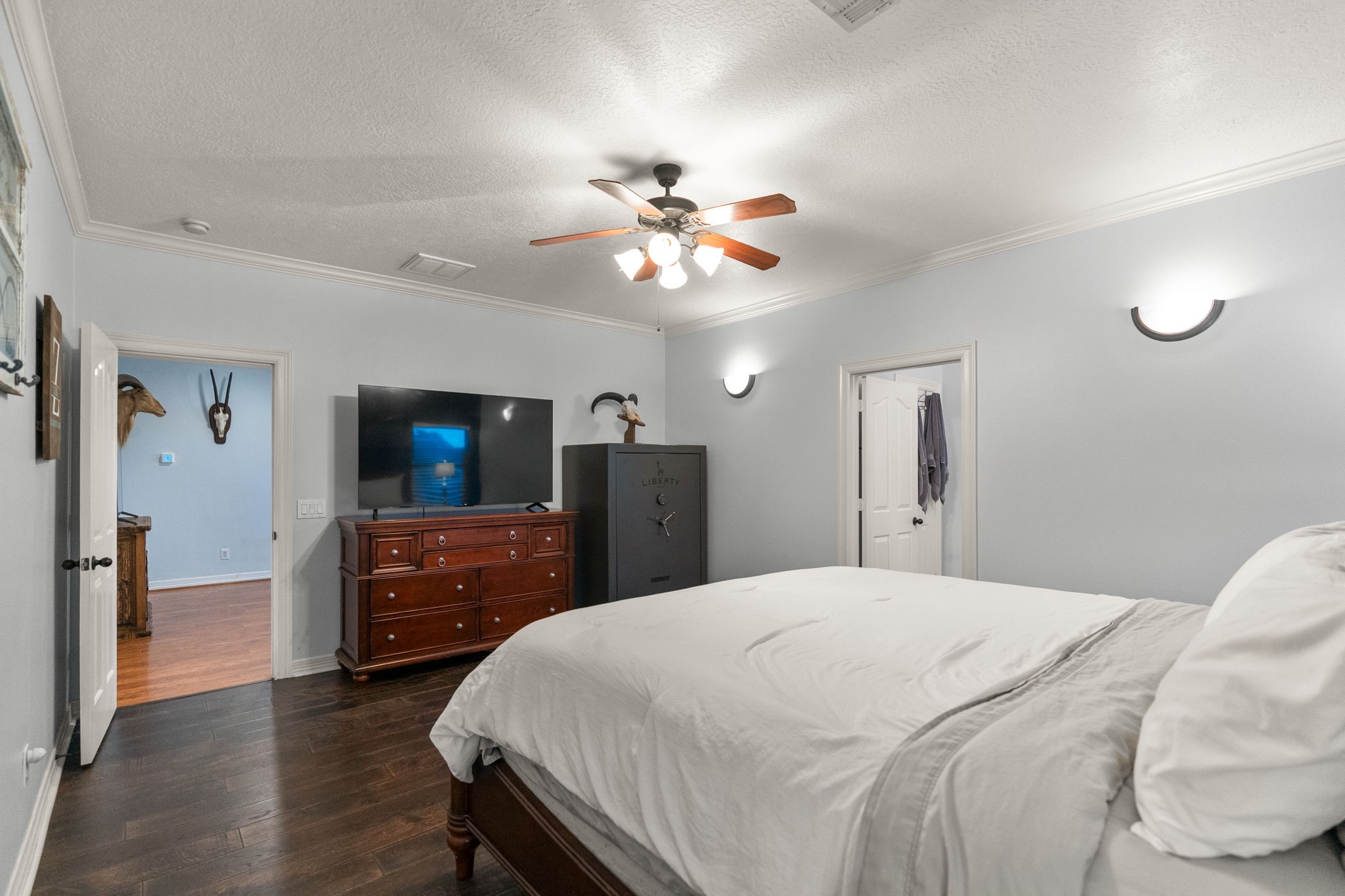 5942 Wildflower Road Sealy, TX 77474 - Photo 14 of 41 a bedroom with a bed and a chandelier