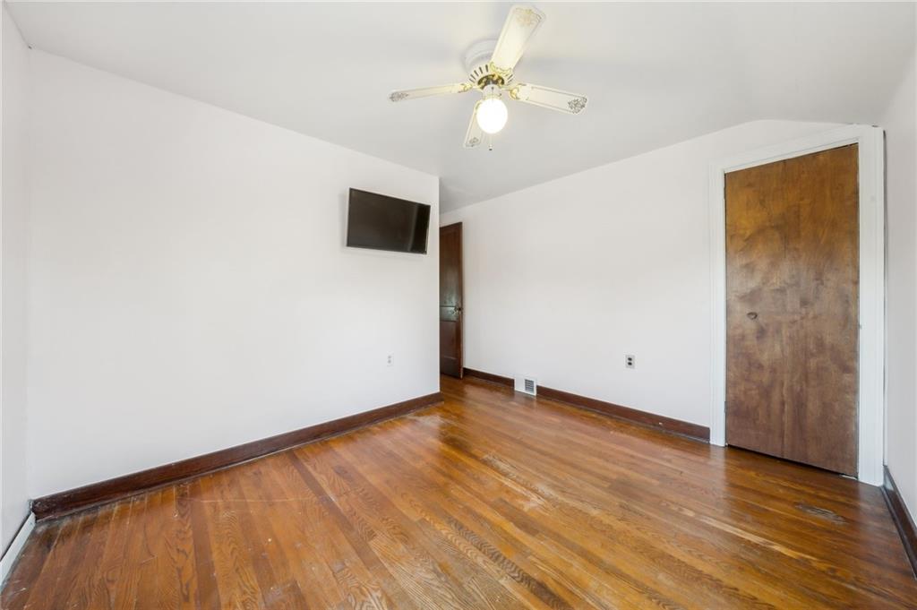 552 Hampton Street Greensburg, PA 15601 - Photo 25 of 36 an empty room with wooden floor and fan