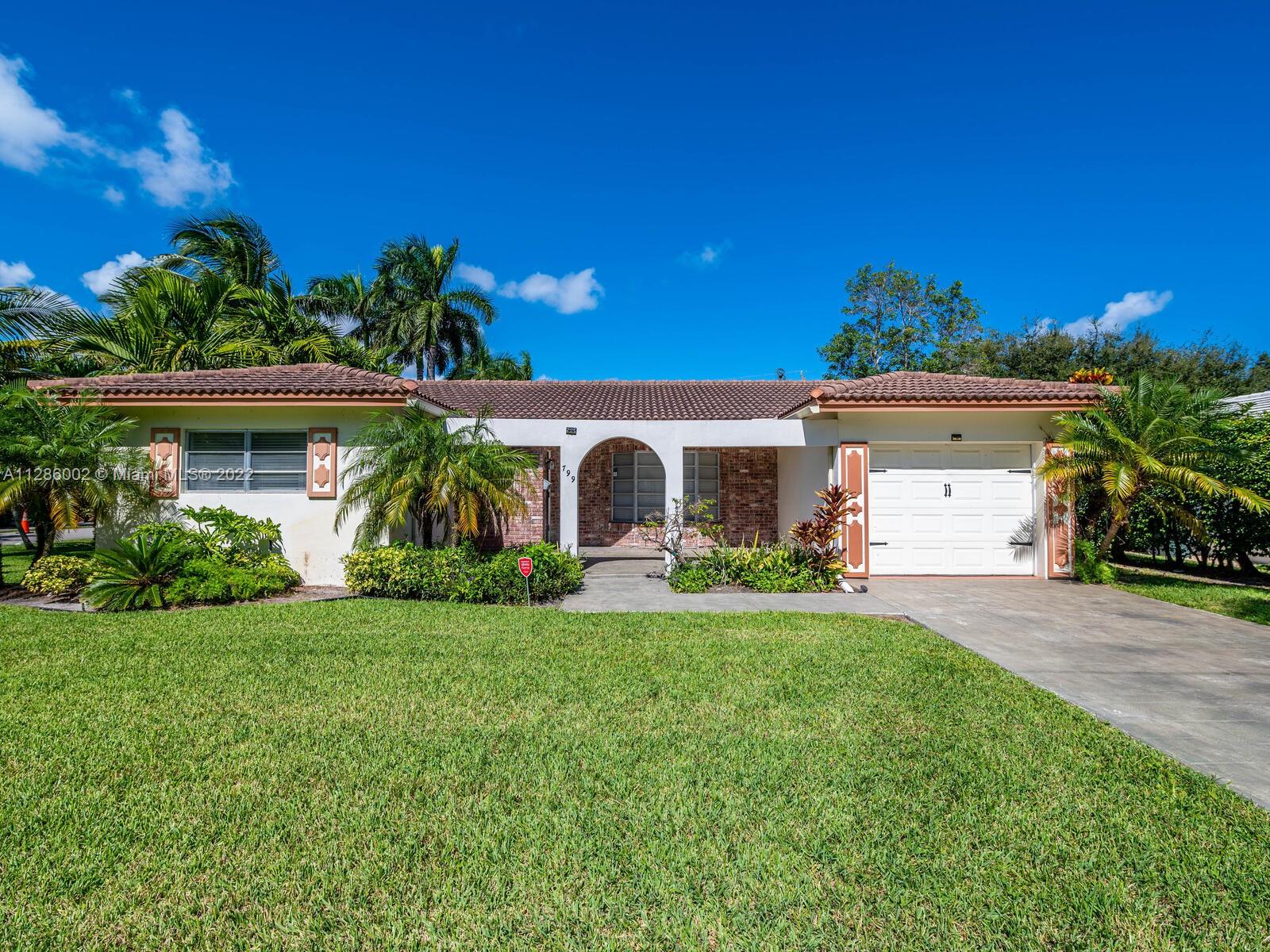 799 Periwinkle Street Boca Raton, FL 33486 - Photo 11 of 55 a front view of a house with a yard and garage