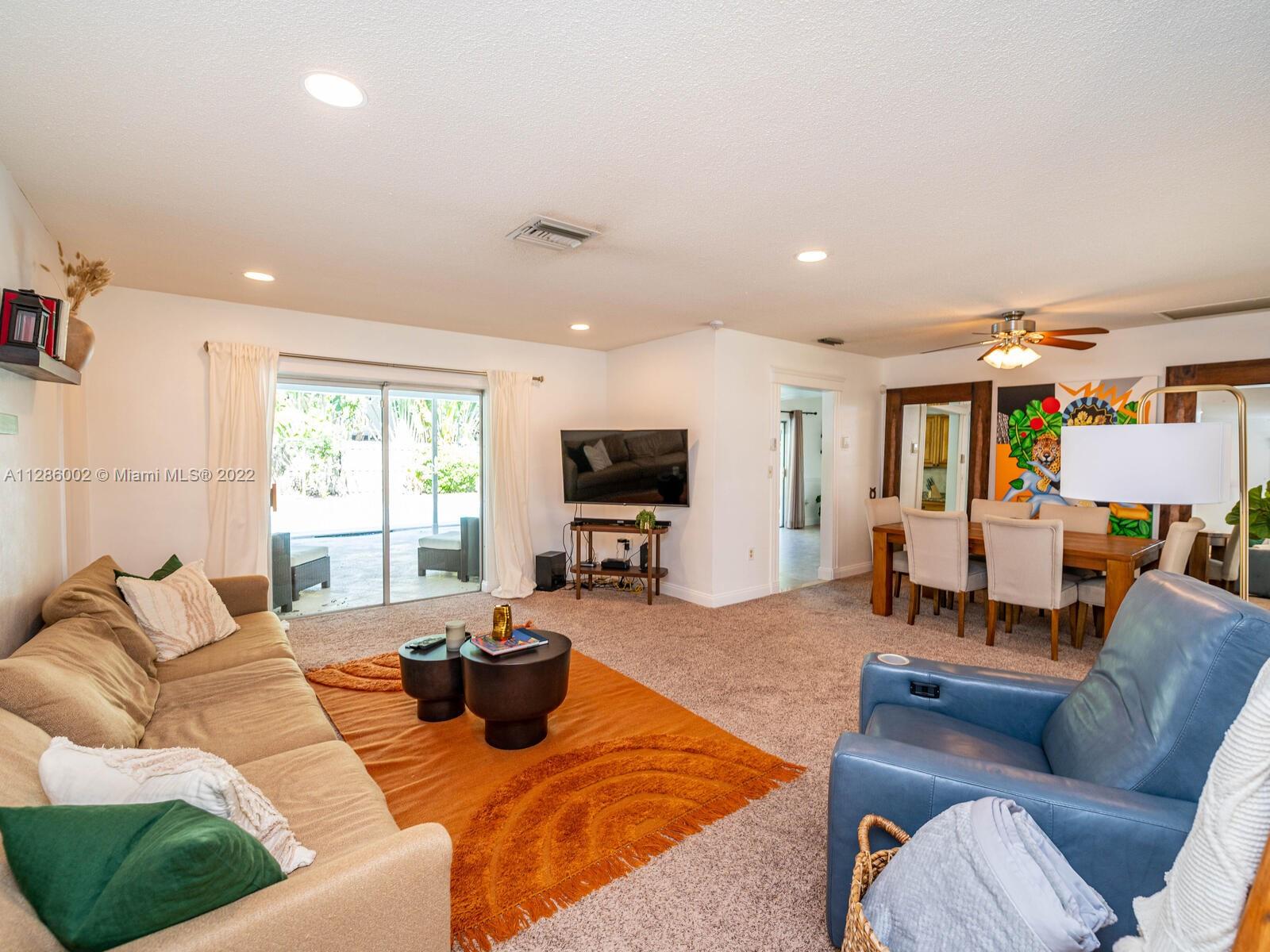 799 Periwinkle Street Boca Raton, FL 33486 - Photo 15 of 55 a living room with furniture wooden floor and a flat screen tv