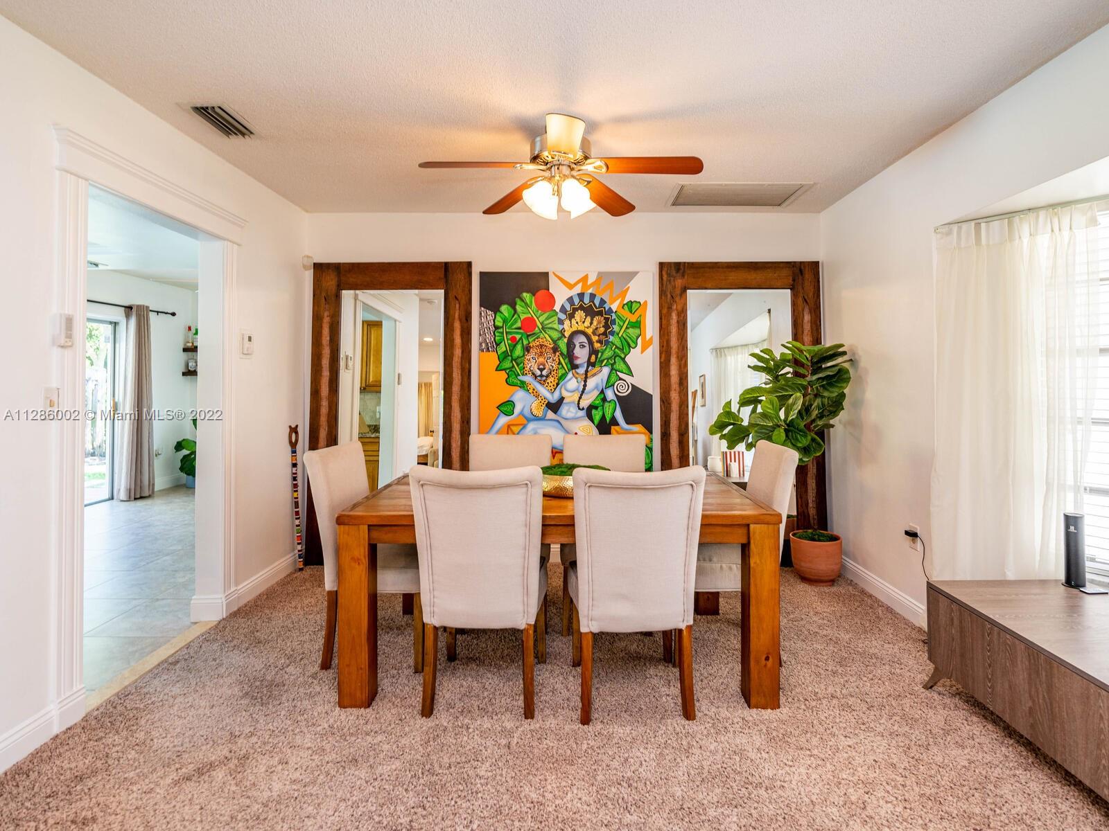 799 Periwinkle Street Boca Raton, FL 33486 - Photo 16 of 55 a view of a dining room with furniture window and wooden floor
