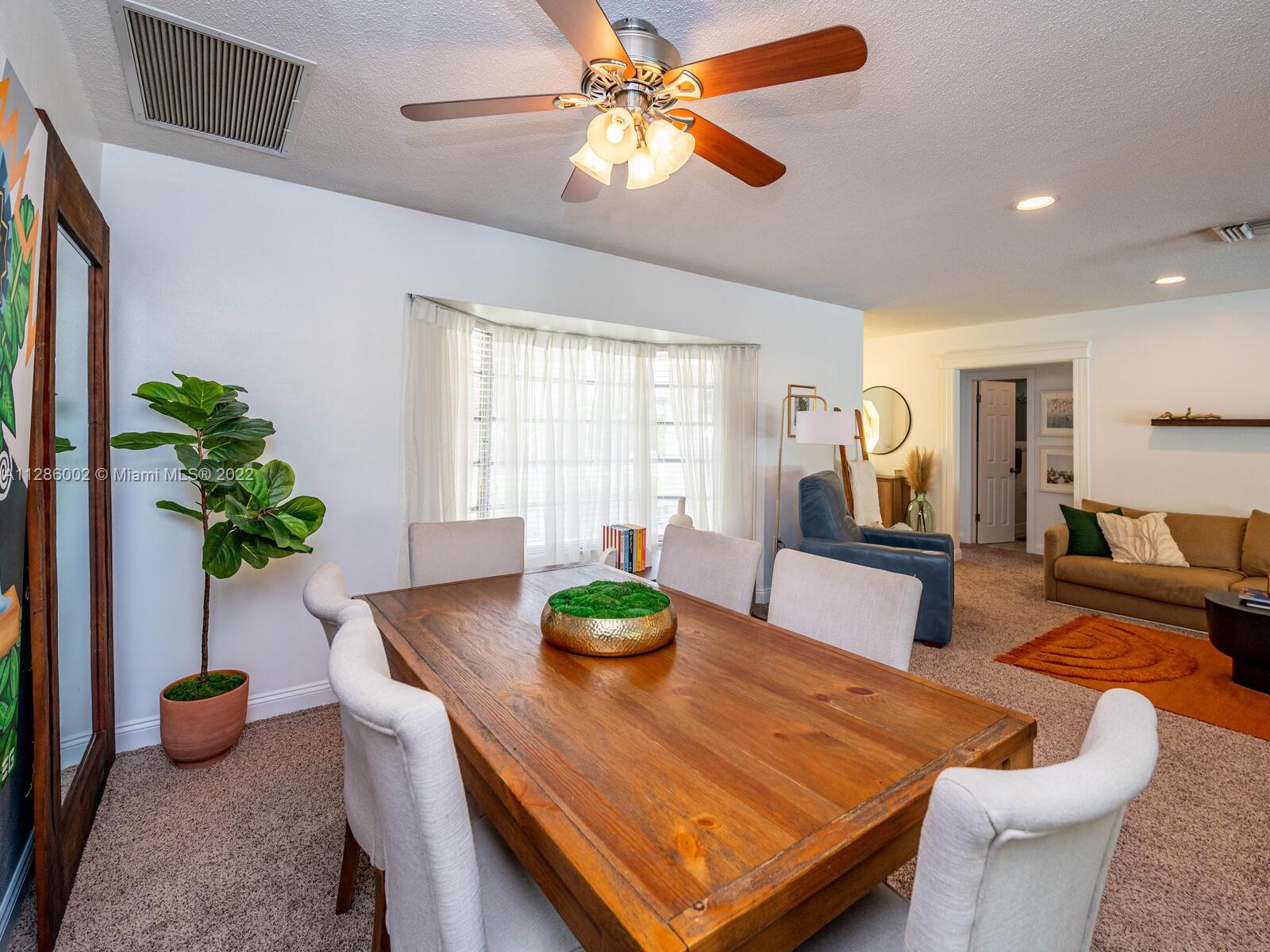799 Periwinkle Street Boca Raton, FL 33486 - Photo 19 of 55 a living room with furniture potted plant and a chandelier