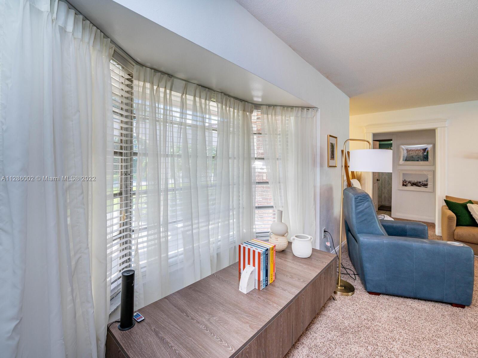 799 Periwinkle Street Boca Raton, FL 33486 - Photo 20 of 55 a living room with furniture and a window