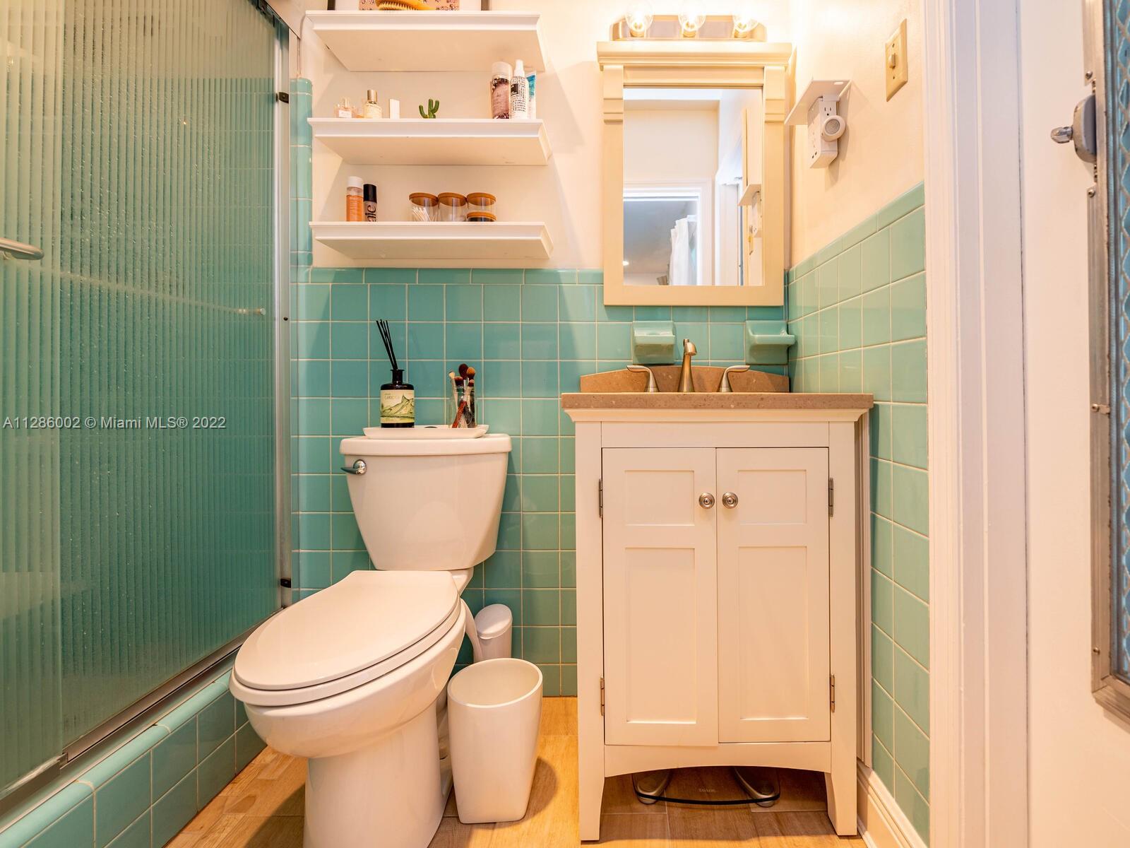 799 Periwinkle Street Boca Raton, FL 33486 - Photo 33 of 55 a bathroom with a sink a toilet and shower