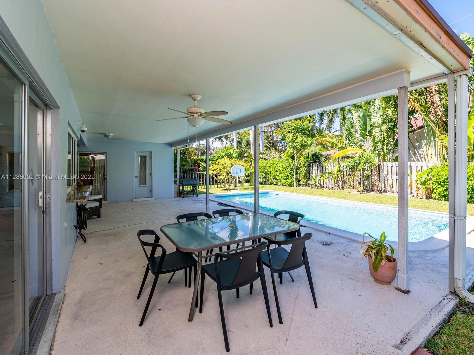 799 Periwinkle Street Boca Raton, FL 33486 - Photo 42 of 55 a view of a dining room with furniture window and outside view