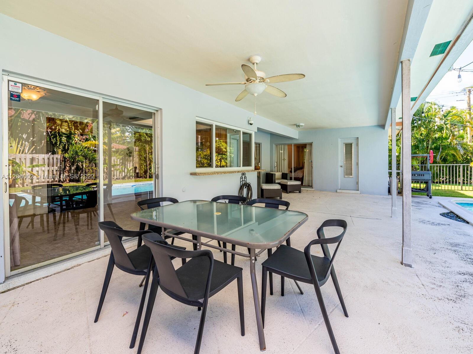 799 Periwinkle Street Boca Raton, FL 33486 - Photo 43 of 55 a view of a dining room with furniture window and wooden floor