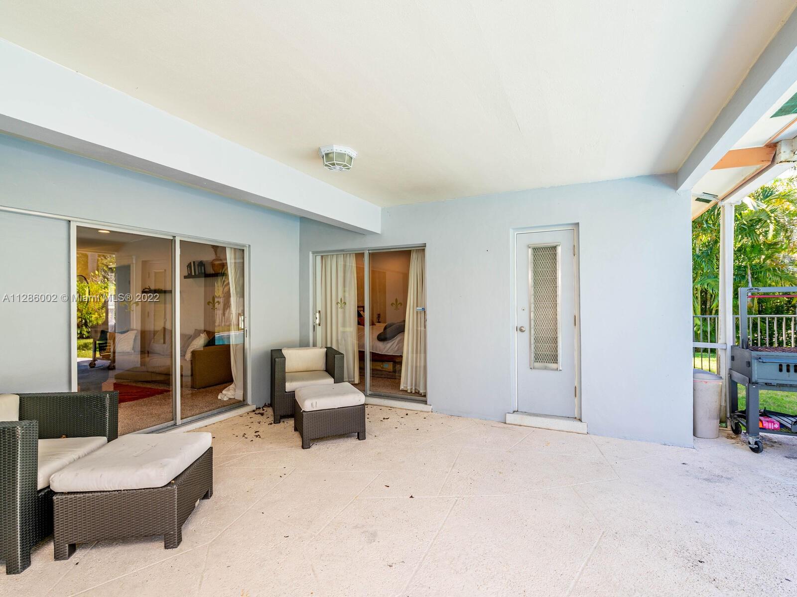 799 Periwinkle Street Boca Raton, FL 33486 - Photo 44 of 55 a bedroom with furniture and large windows