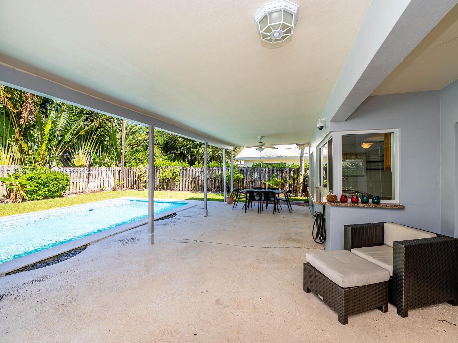 799 Periwinkle Street Boca Raton, FL 33486 - Photo 45 of 55 a living room with furniture and a large window