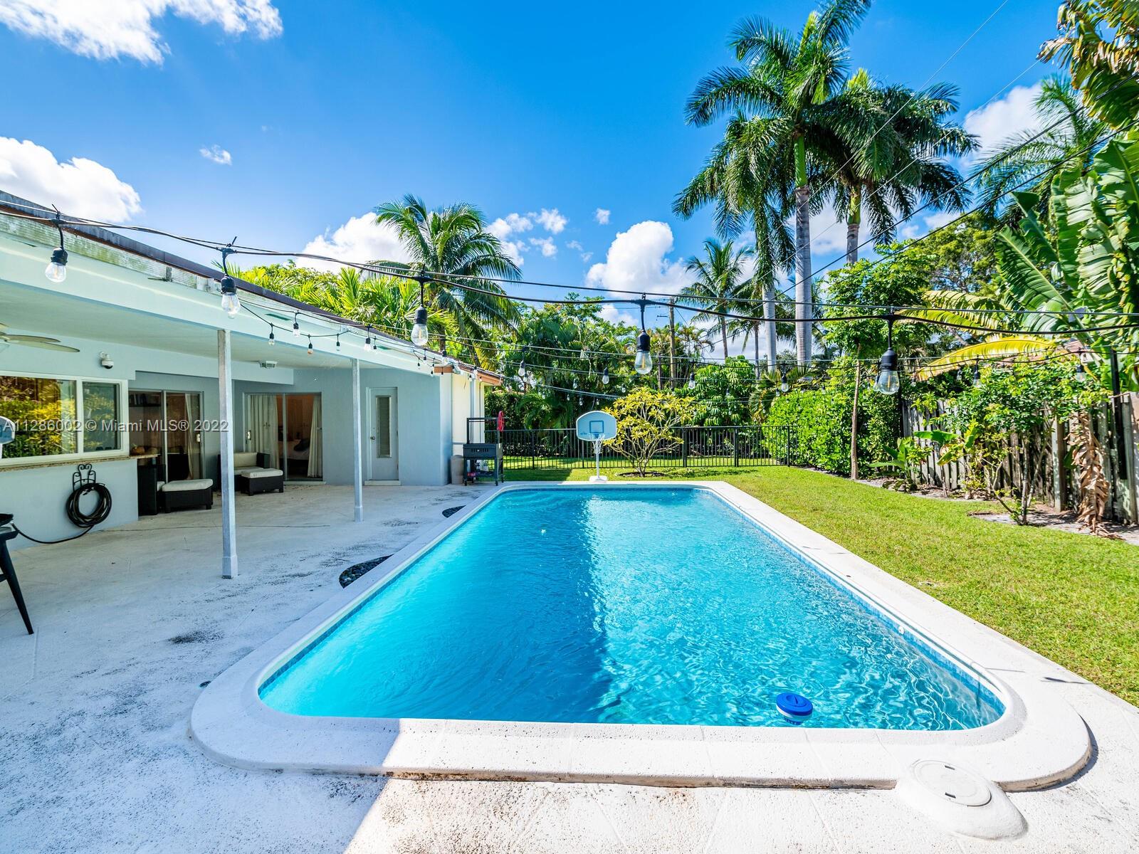 799 Periwinkle Street Boca Raton, FL 33486 - Photo 49 of 55 a view of a backyard with plants and a patio