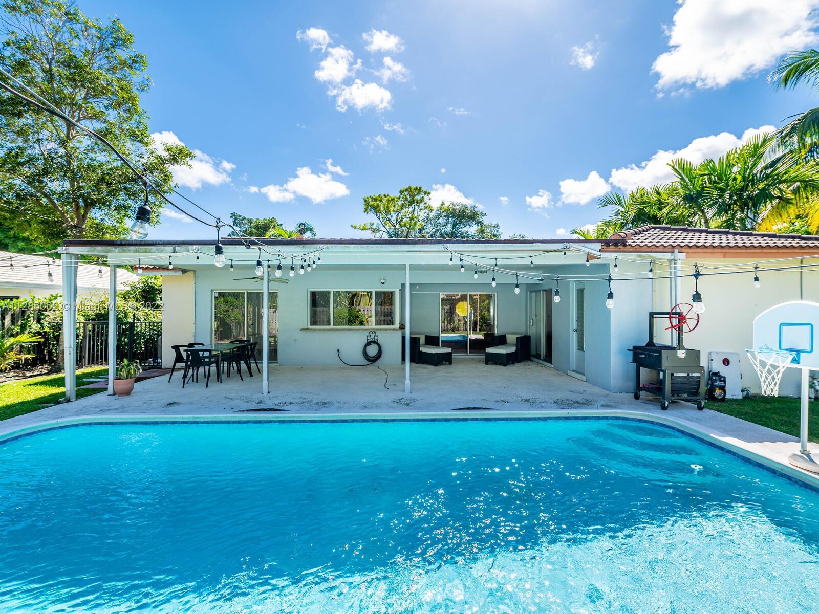 799 Periwinkle Street Boca Raton, FL 33486 - Photo 51 of 55 a view of an house with backyard porch and sitting area