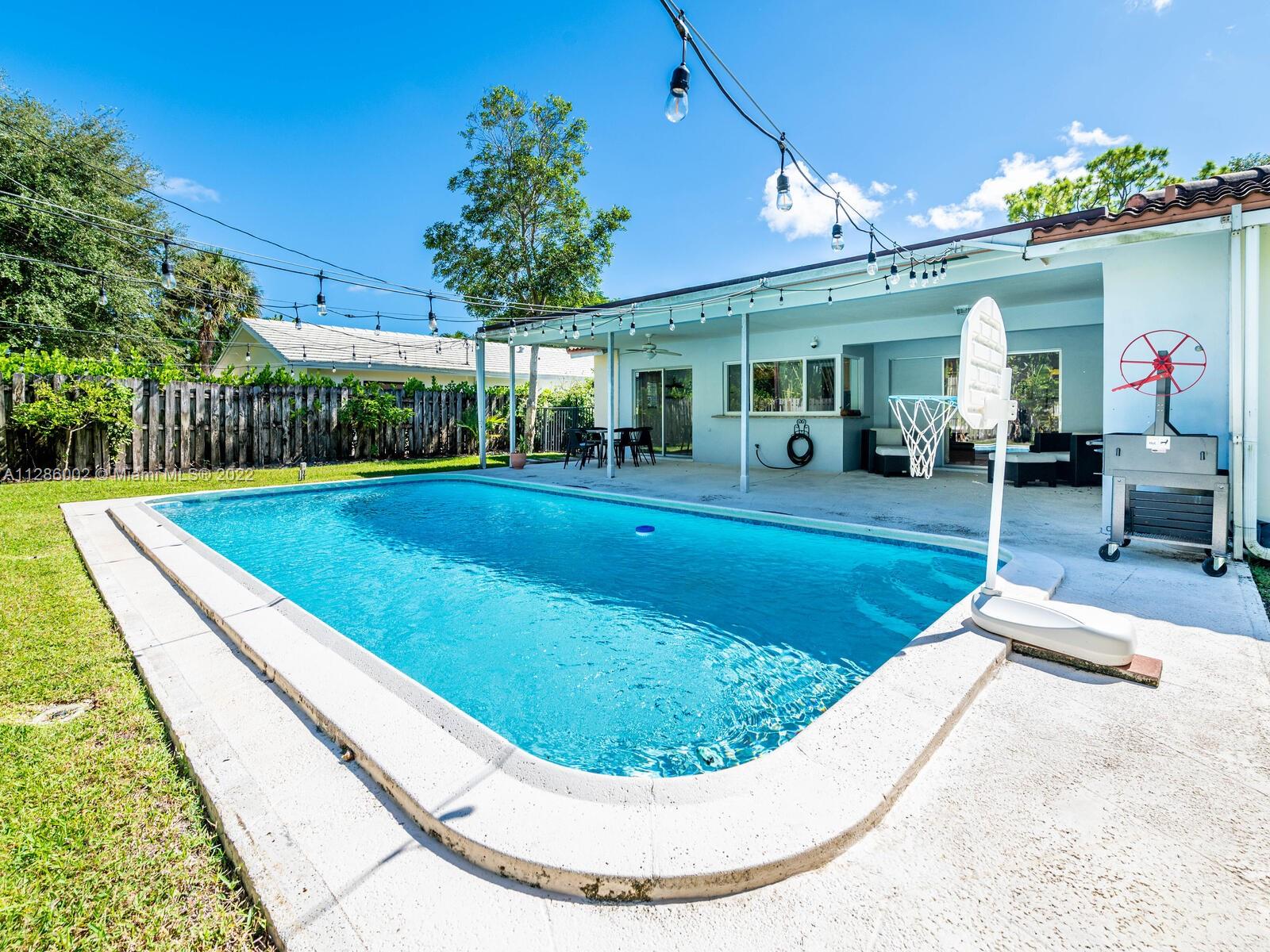 799 Periwinkle Street Boca Raton, FL 33486 - Photo 54 of 55 a view of a house with swimming pool