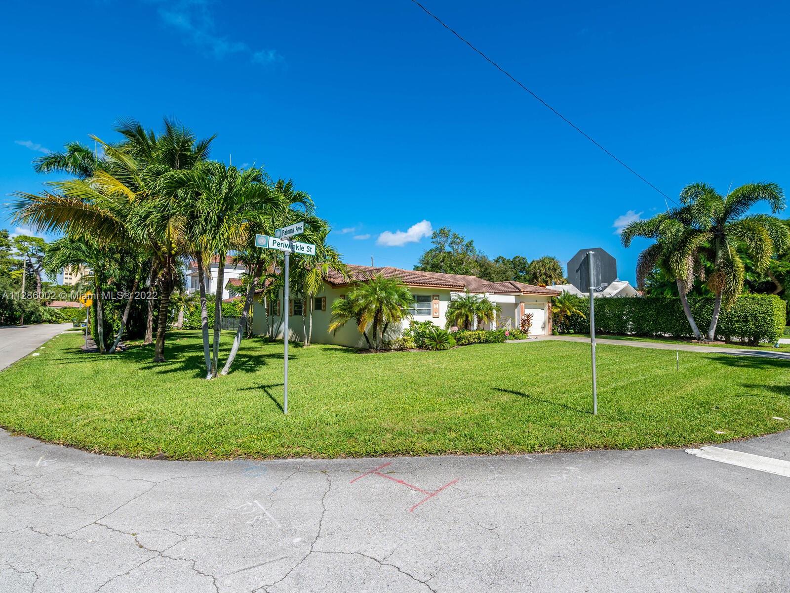 799 Periwinkle Street Boca Raton, FL 33486 - Photo 10 of 55 a view of a house with a big yard and potted plants