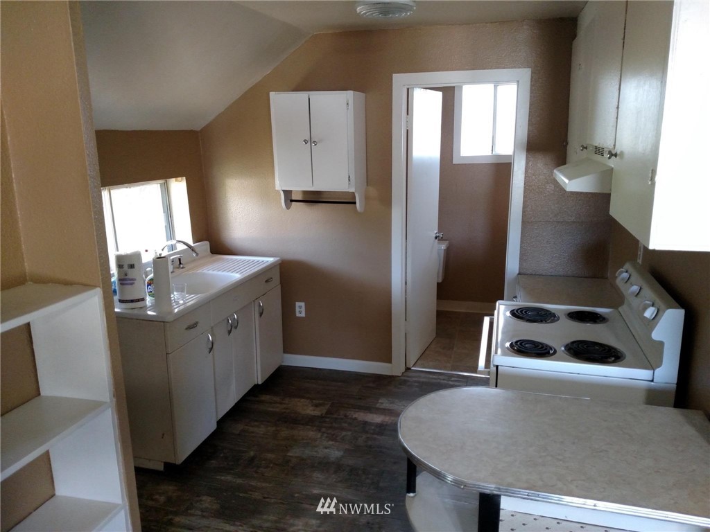 565 McNaught Road South, Unit 1&2 Roy, WA 98580 - Photo 5 of 14 a kitchen with sink refrigerator and window