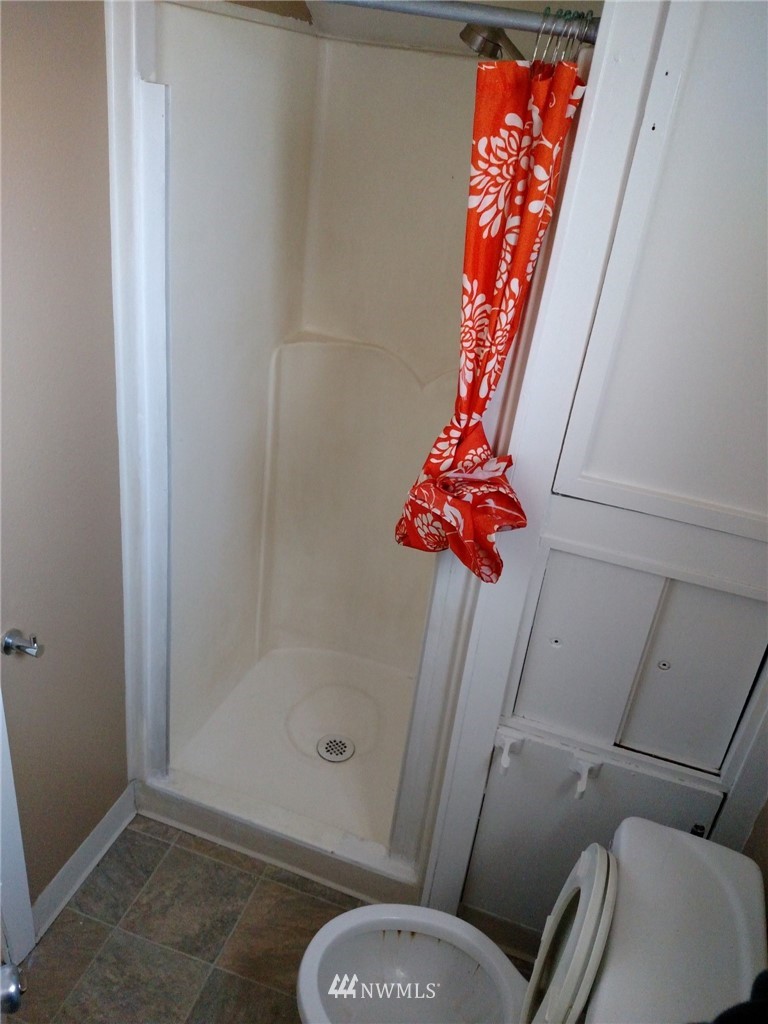 565 McNaught Road South, Unit 1&2 Roy, WA 98580 - Photo 9 of 14 a bathroom with a shower and toilet
