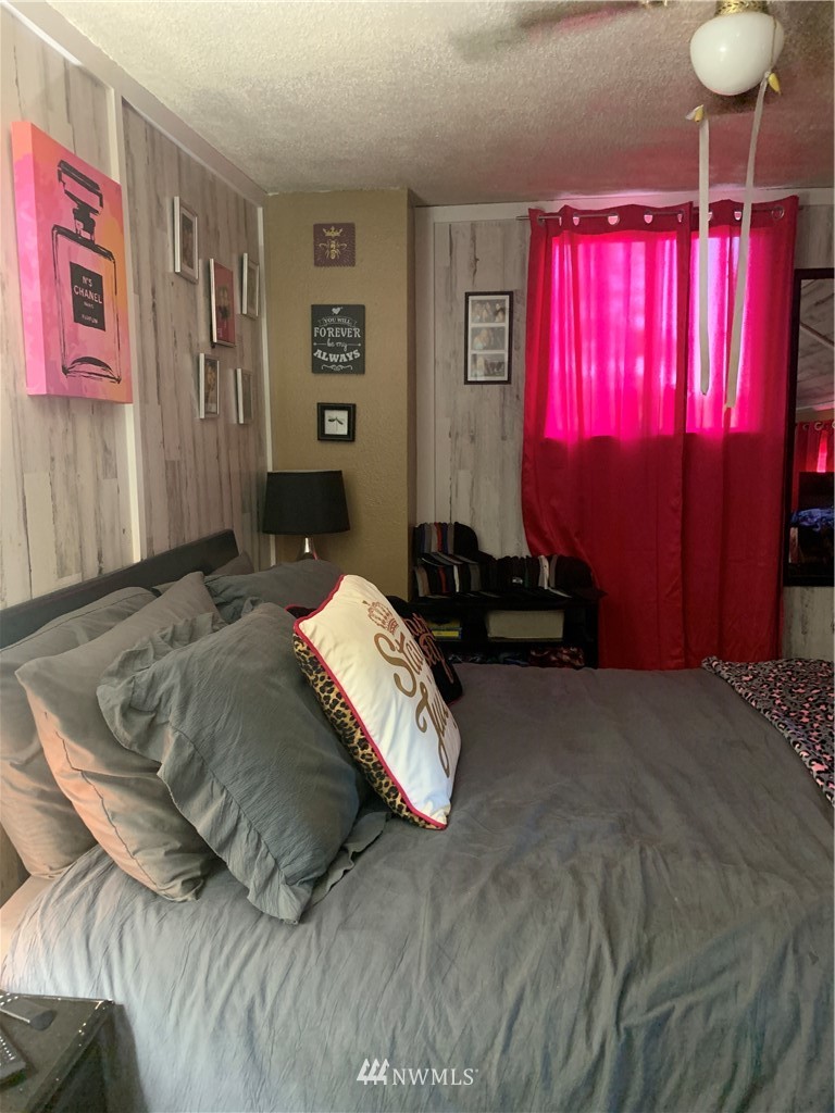 565 McNaught Road South, Unit 1&2 Roy, WA 98580 - Photo 10 of 14 a bedroom with a bed and window