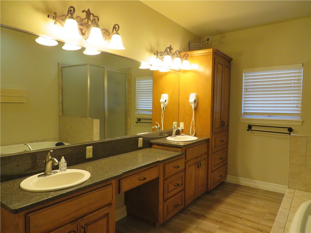 5803 South Oso Parkway Corpus Christi, TX 78414 - Photo 18 of 39 a bathroom with a double vanity sink and a mirror