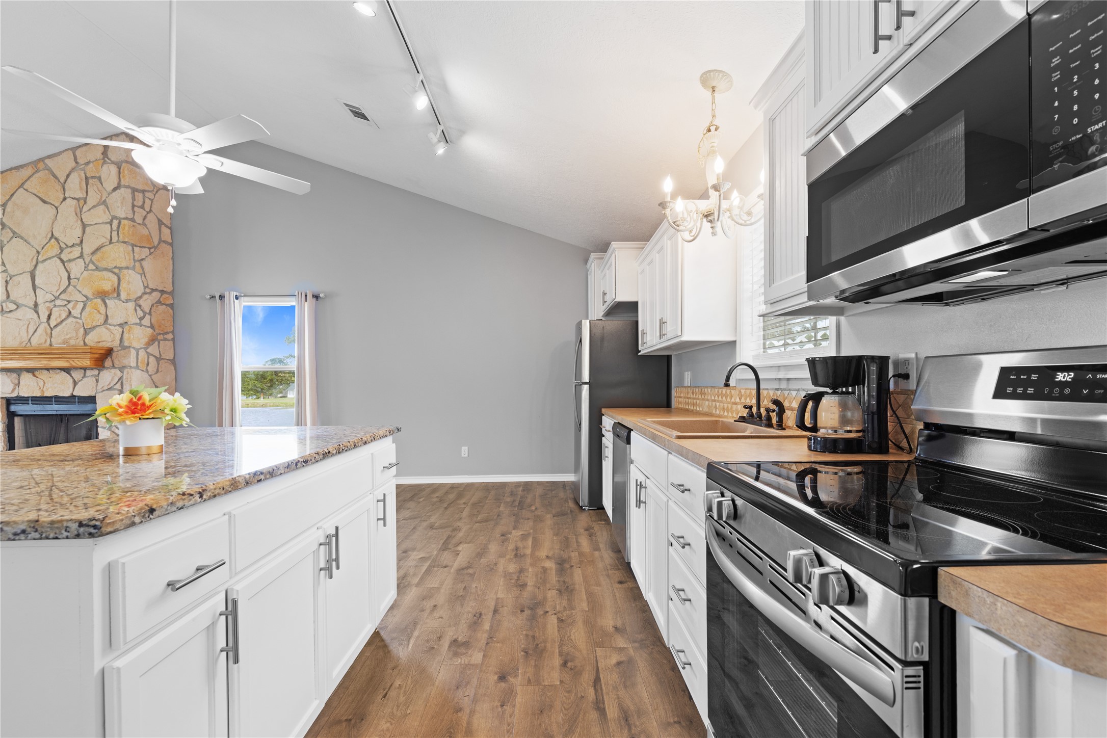 140 Meadowview Drive Trinity, TX 75862 - Photo 5 of 27 a kitchen with stainless steel appliances granite countertop a sink a stove and a wooden floors
