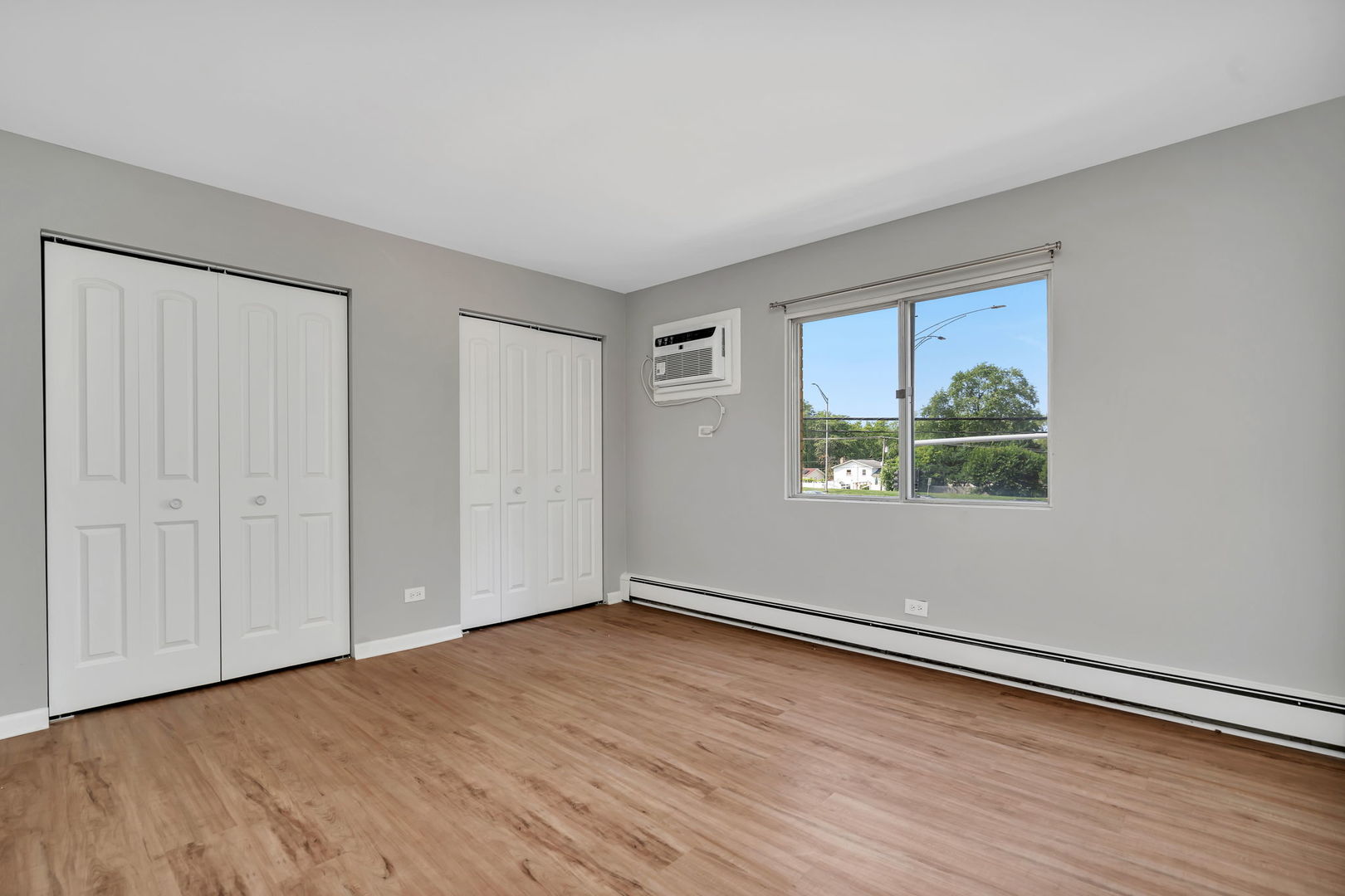 909 Plainfield Road, Unit 12 Darien, IL 60561 - Photo 10 of 10 a view of an empty room with wooden floor and a window
